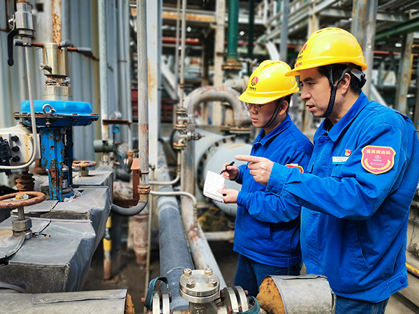 600 圖二：12日下午13時，在動力車間氨區(qū)，趁著午飯休息的空擋，公司勞模安朝陽給90后徒弟岳維哲講解流化床鍋爐氨水配置注意事項(xiàng)。.jpg